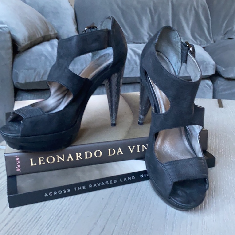 Unique black high heels with crossover uppers.